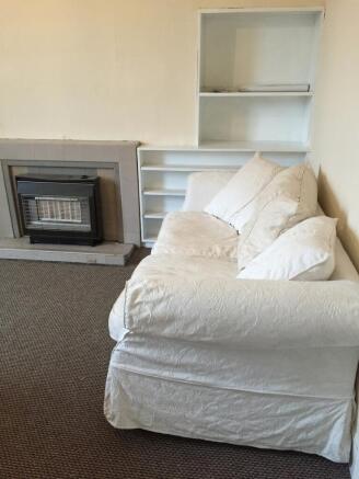 A cozy living room featuring a comfortable whit...