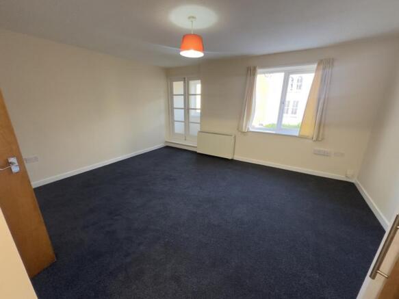 A spacious and well-lit modern living room, per...