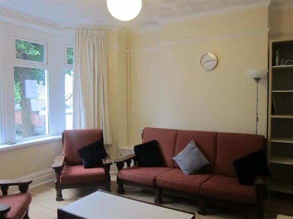 Bright lounge with a bay window and comfy seati...