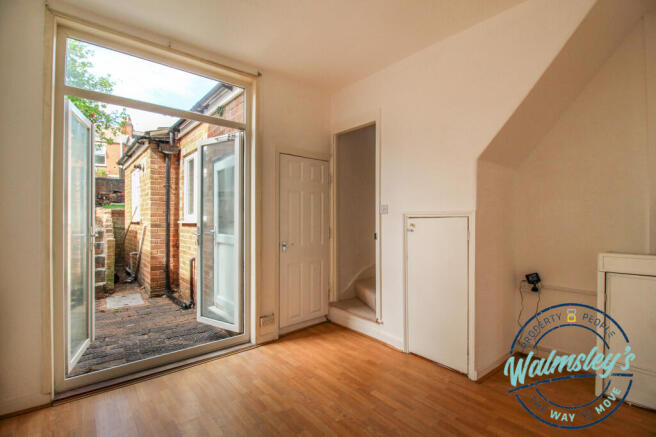 Ground floor rear sitting room with under stairs s