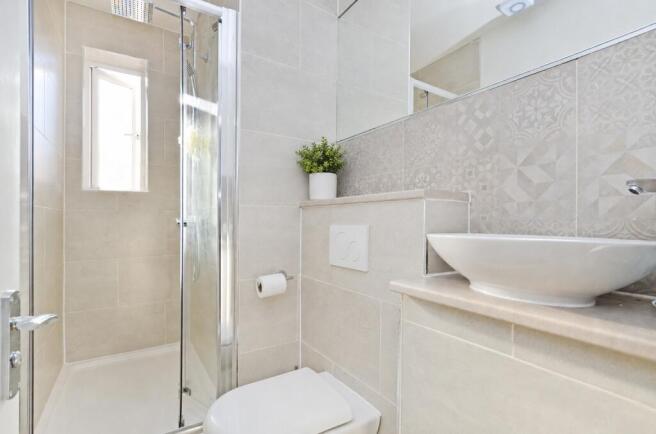 Bright, modern shower room with stylish tiling...