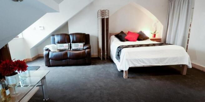 Large attic master bedroom with private sofa ar...