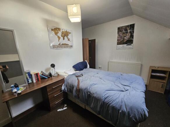 A well-lit, neatly maintained double bedroom fe...