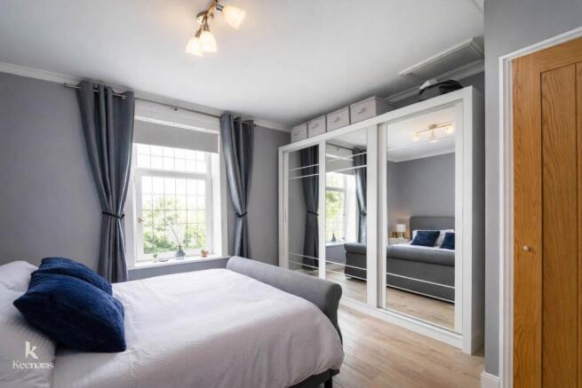 Modern bedroom with mirrored wardrobe.jpg