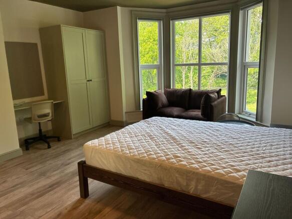 Spacious bright bedroom with bay window views...