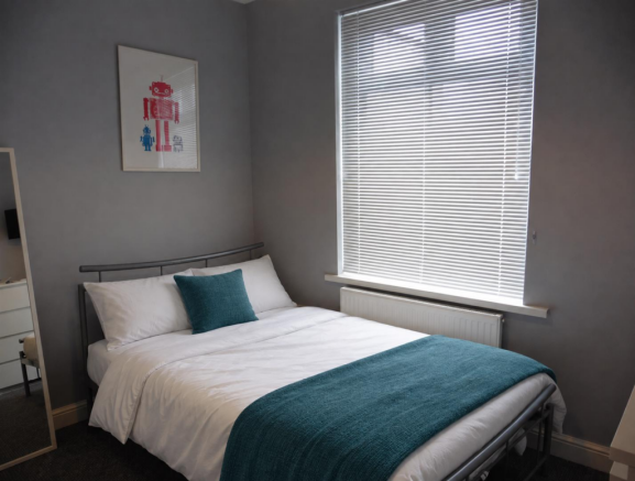 White bedding with teal accents.png