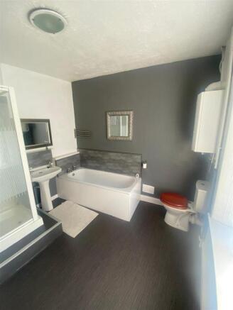 Stylish bathroom with full bath and shower cubi...