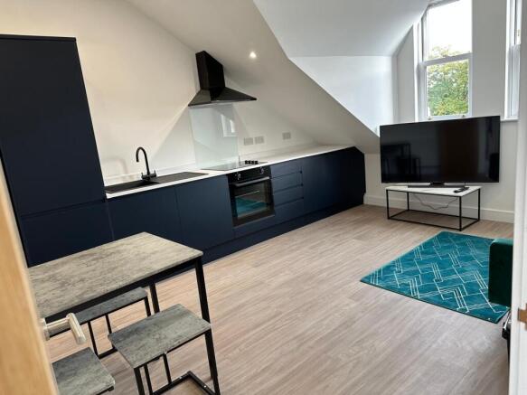 Modern open-plan kitchen-living area with sleek...