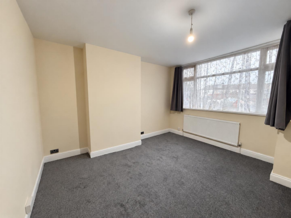 Empty Cream Room with Window and Radiator.png