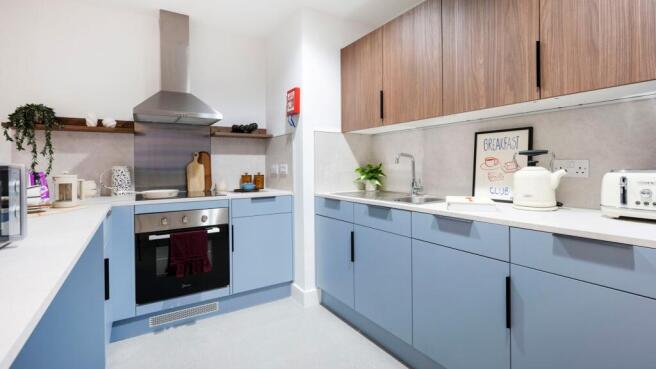 Bright, modern kitchen with blue lower cabinets...