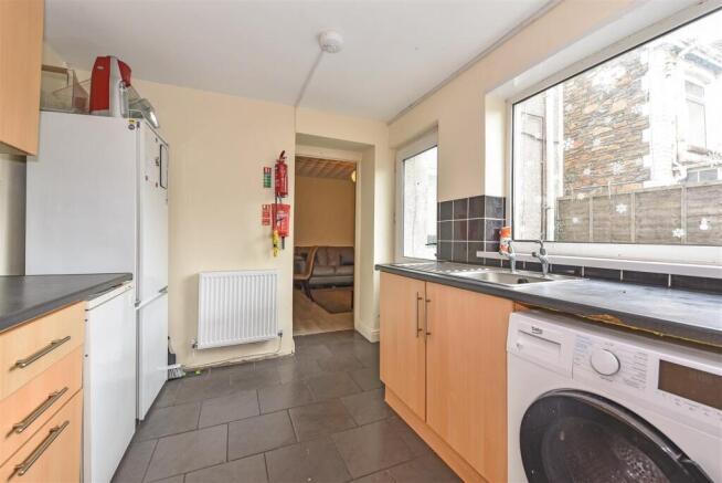 Bright kitchen with large windows and appliance...
