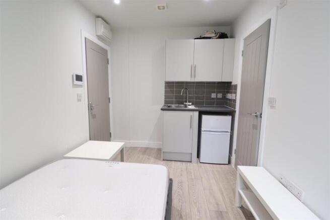 Bright, compact studio with a small fitted kitc...