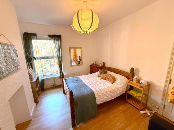 Bright bedroom with stylish wooden flooring...