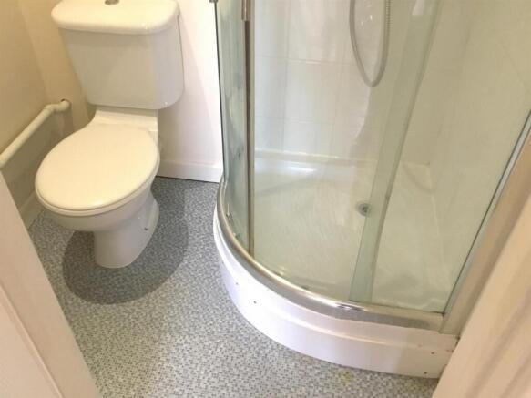 Modern private ensuite with sleek shower cubicl...