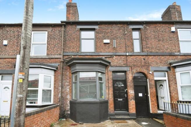 Brick terraced house with a bay window and pain...