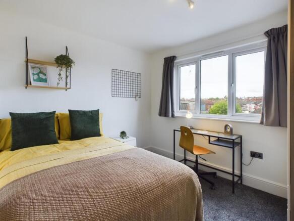 A bright and inviting double bedroom featuring ...