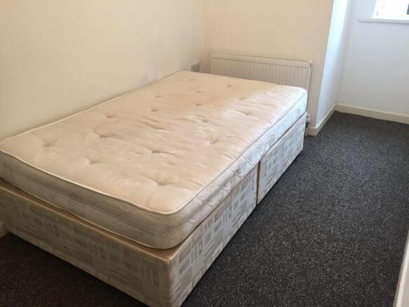 Bright bedroom with double bed and plush carpet...