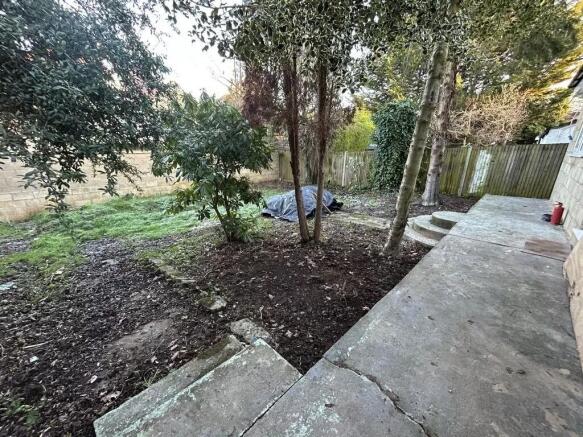 Private rear garden with a paved patio area lea...