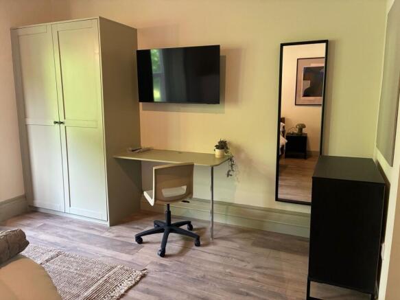 Modern study area with a wall-mounted TV....