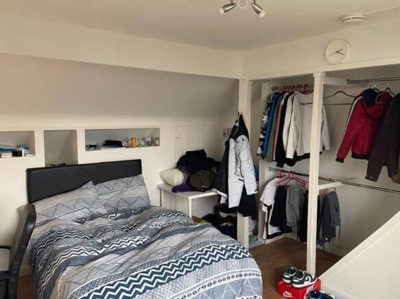 A cozy double bedroom with a comfortable bed an...