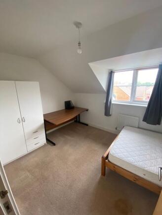 Bright, neatly presented bedroom with a large d...