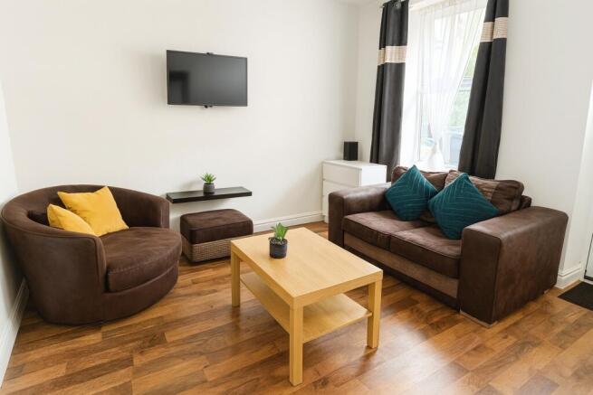 A bright, comfortable living room featuring a l...