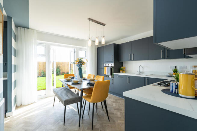 A modern and stylish kitchen with gray cabinets, a dining table with yellow chairs