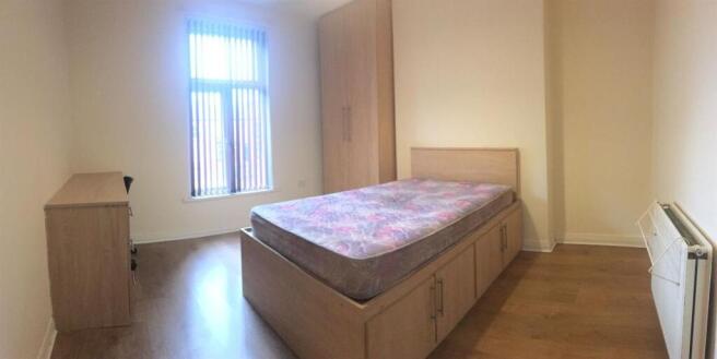 Bright bedroom with ample integrated storage...