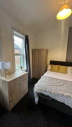 A cozy double bedroom featuring a comfortable b...