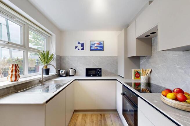 Bright and modern kitchen with ample natural li...