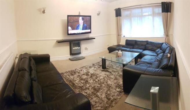 Bright, neatly presented living room with two l...