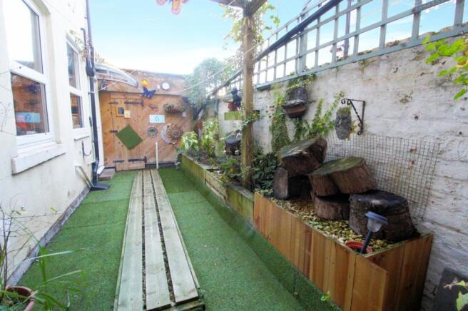 REAR COURTYARD LEADING TO GARAGE