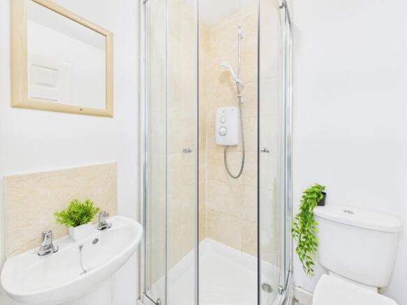 Bright, modern bathroom with a corner glass sho...