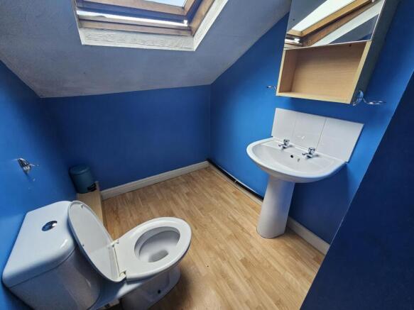 Bright upstairs bathroom with skylight, white p...