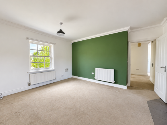 Balanced daylight brightens a green-accented room