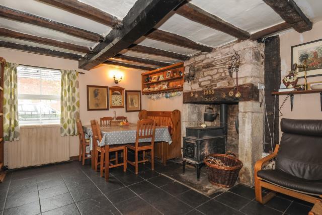 Dining area with beams and wood burning stove