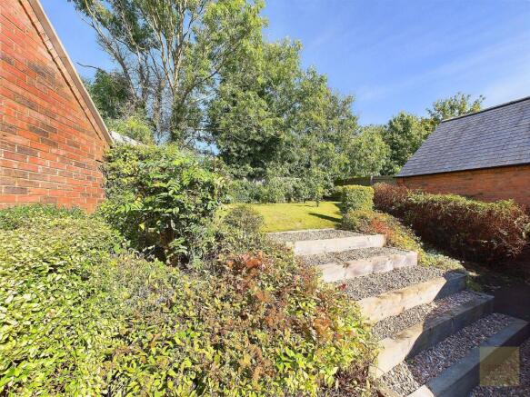 Steps leading to the rear garden next to the garage
