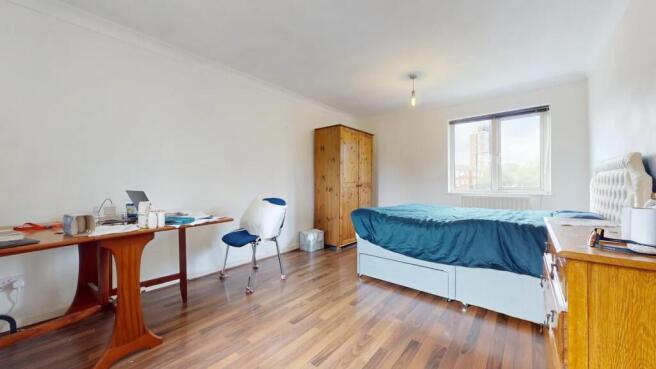 Bright and spacious master bedroom featuring a ...