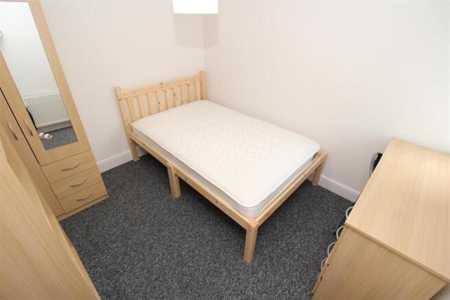 Bright and tidy room with essential storage...