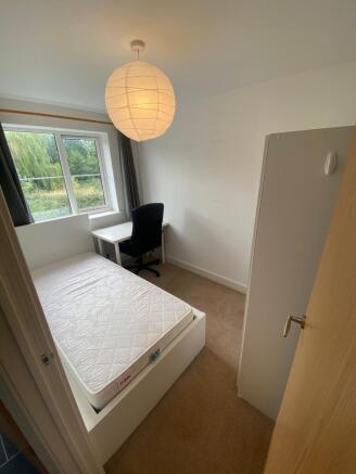 Bright, simply furnished single bedroom with a ...