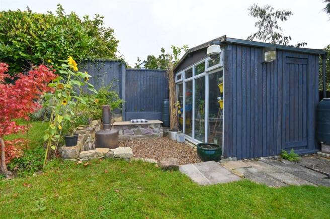 Landscaped gardens and patio areas to rear