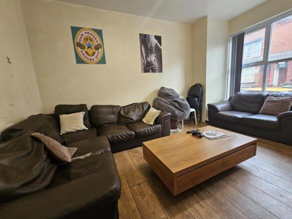 A spacious and inviting living room featuring a...