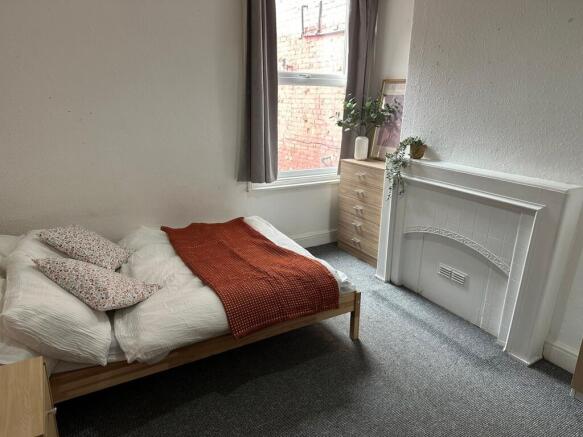 A bright and cozy double bedroom featuring a co...