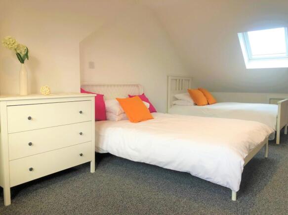 A bright and welcoming double bedroom featuring...