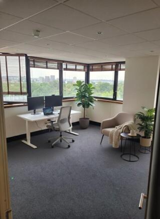 Bright corner workspace with large wrap-around ...