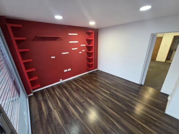 Modern lounge with feature wall and wood floors...