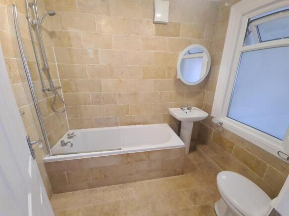 Bright modern bathroom with bath and shower...