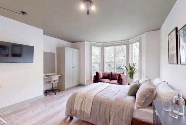 Bright bedroom with bay window and study area...
