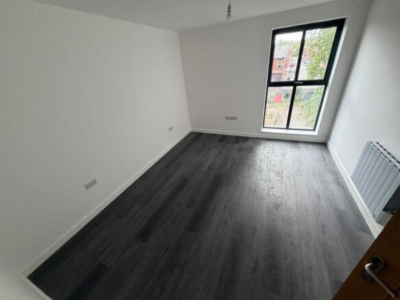 Bright bedroom with sleek modern flooring...