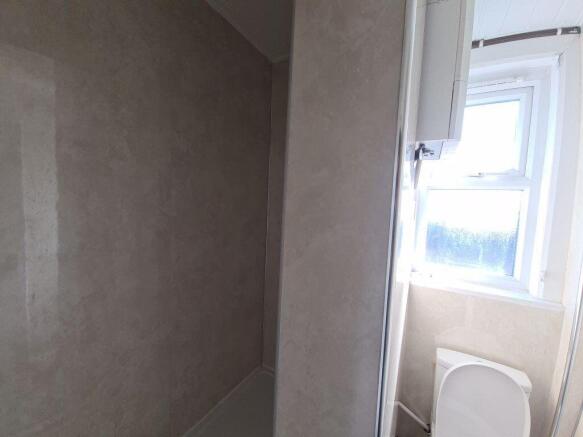 A bright and clean bathroom featuring a large w...